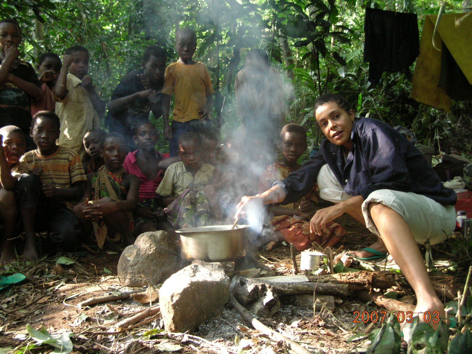 Tuyeni Cooking on three stone stove