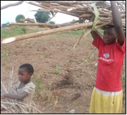 Chlidren carrying bundles of wood.